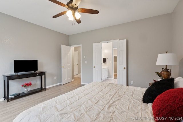 bedroom featuring light wood-type flooring, ensuite bath, and ceiling fan