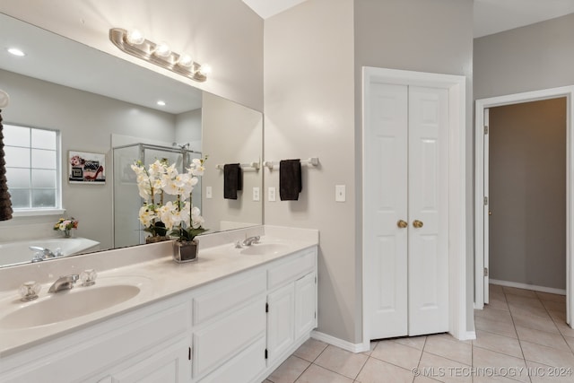 bathroom with tile patterned floors, vanity, and a shower with shower door