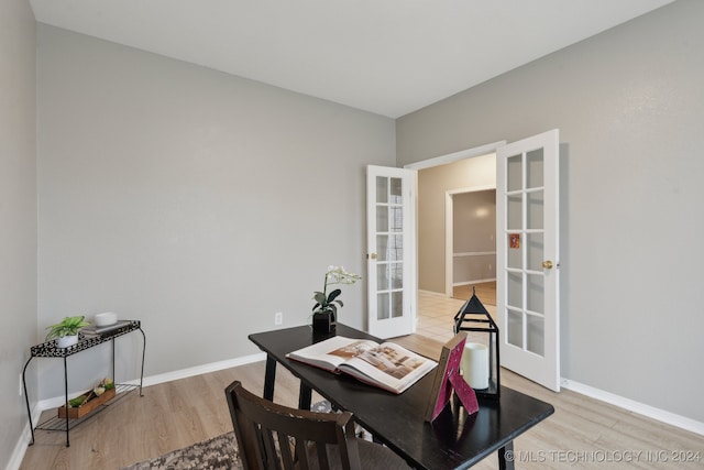 home office with hardwood / wood-style flooring and french doors