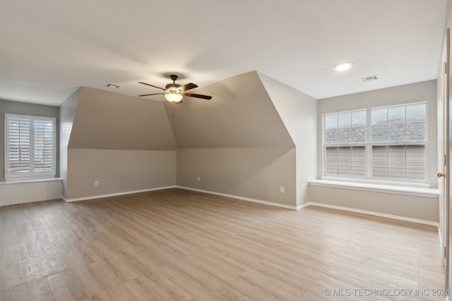 additional living space featuring ceiling fan, light wood-type flooring, and a wealth of natural light