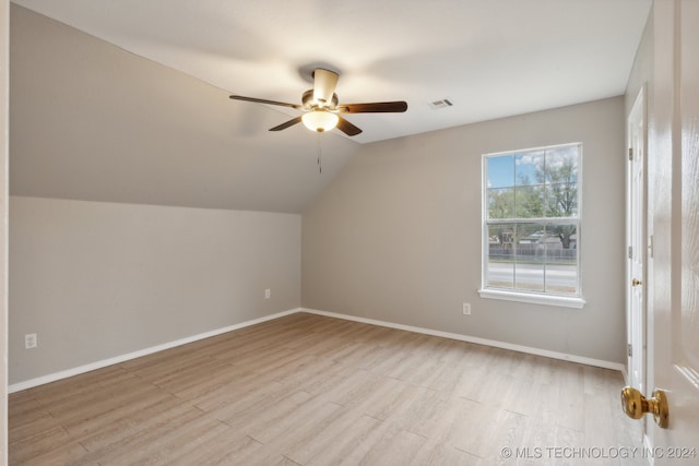 additional living space with ceiling fan, vaulted ceiling, and light hardwood / wood-style flooring