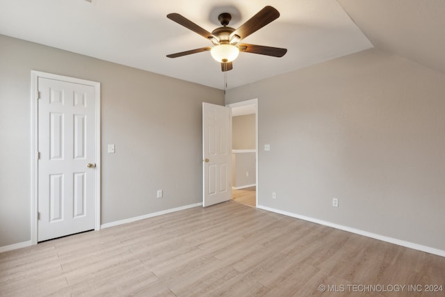 unfurnished bedroom with ceiling fan, lofted ceiling, and light hardwood / wood-style flooring