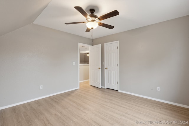 unfurnished bedroom with ceiling fan and light wood-type flooring