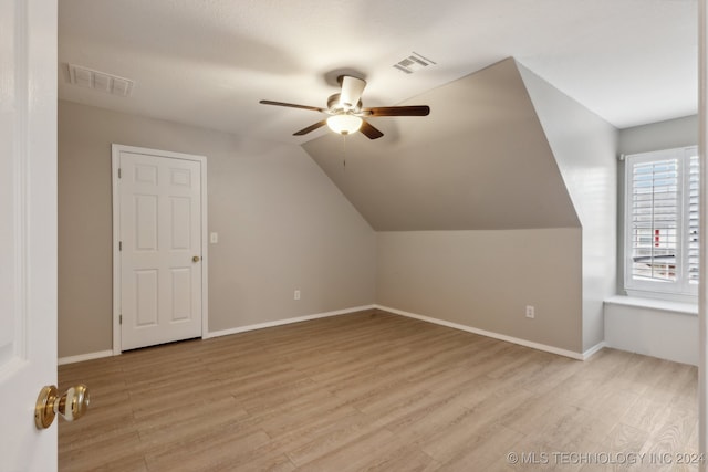 additional living space featuring ceiling fan, vaulted ceiling, and light hardwood / wood-style flooring