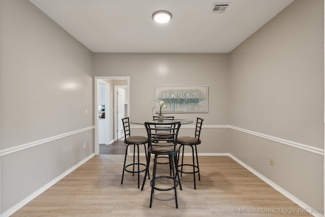 dining space with light hardwood / wood-style floors