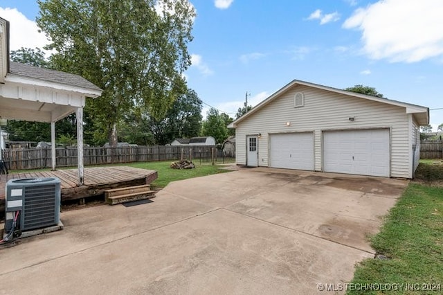 garage with central AC and a lawn