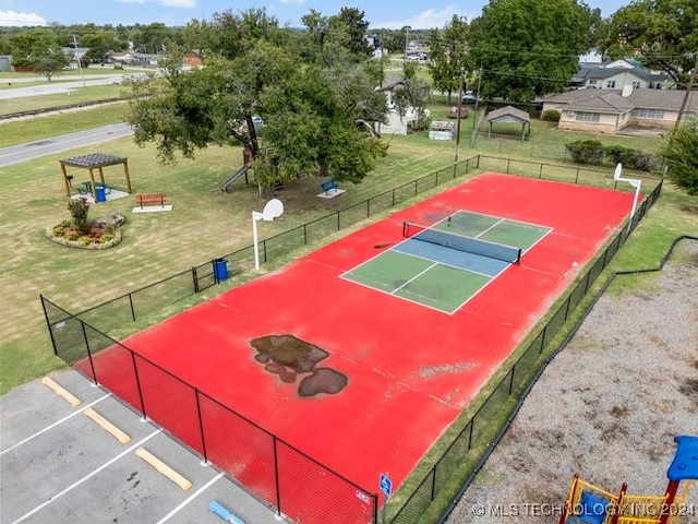 view of sport court featuring a yard