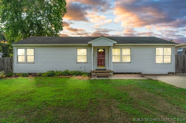 ranch-style house featuring a lawn