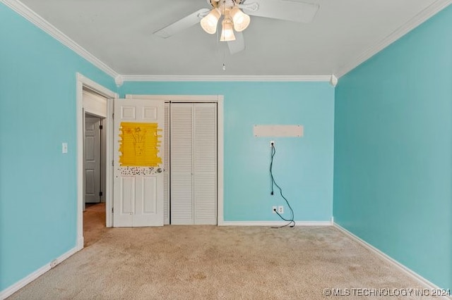 unfurnished bedroom with ornamental molding, light carpet, ceiling fan, and a closet