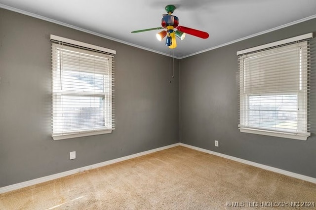 unfurnished room featuring light carpet, ornamental molding, and a healthy amount of sunlight