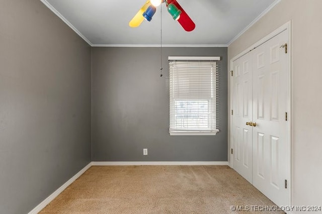 carpeted empty room with ornamental molding and ceiling fan