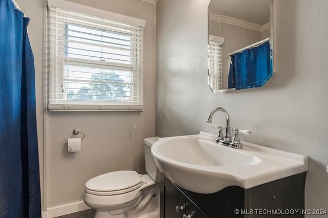 bathroom with crown molding, toilet, and vanity