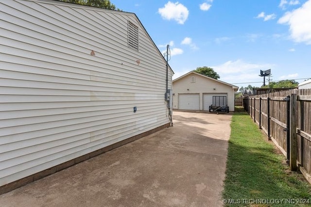 view of side of property with an outdoor structure and a garage