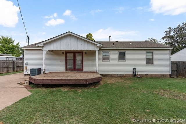 rear view of property featuring a yard, a wooden deck, and central AC unit