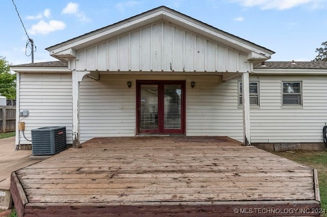 back of property with french doors, a deck, and central air condition unit