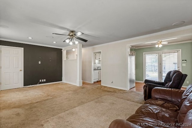 carpeted living room with ceiling fan and ornamental molding