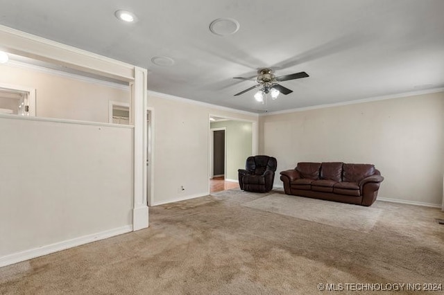 living room with ceiling fan, crown molding, and light carpet