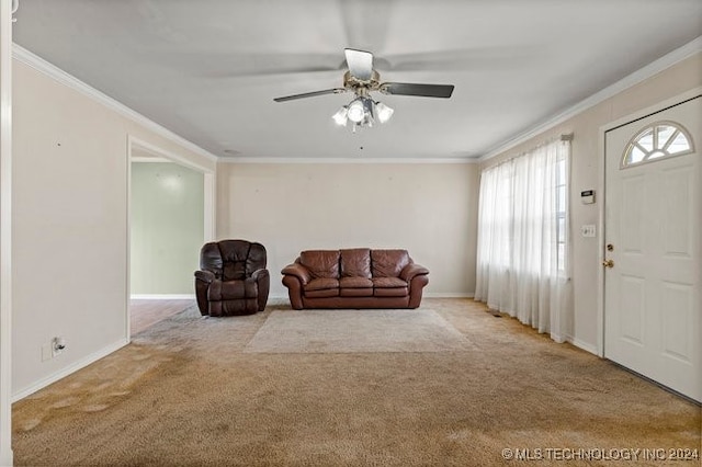 living room featuring ornamental molding, light colored carpet, and ceiling fan