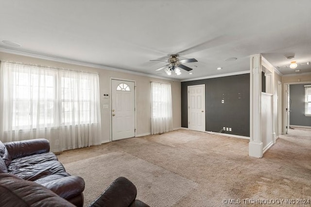 carpeted living room with crown molding and ceiling fan