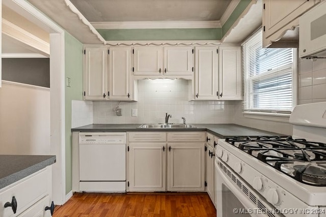 kitchen featuring sink, white appliances, backsplash, white cabinetry, and light wood-type flooring