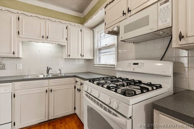 kitchen featuring white appliances, dark wood-type flooring, sink, backsplash, and white cabinetry