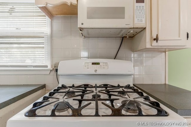 interior space featuring tasteful backsplash and white appliances