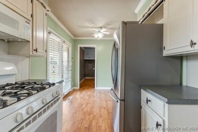 kitchen with ceiling fan, ornamental molding, white appliances, white cabinetry, and light wood-type flooring