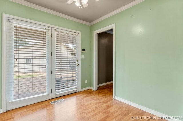 spare room with ornamental molding, light hardwood / wood-style flooring, and ceiling fan