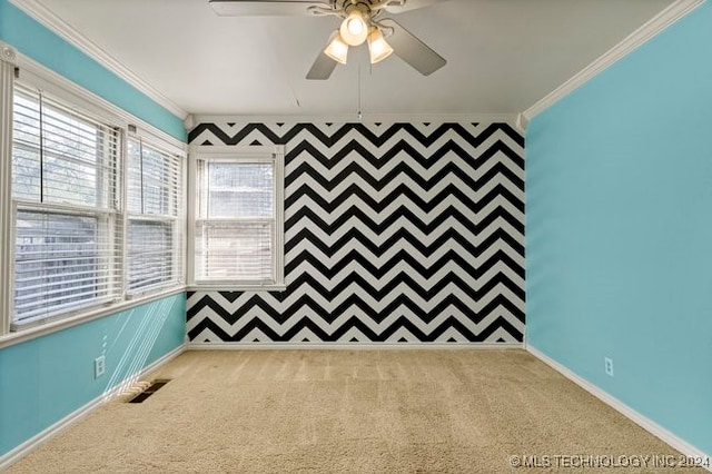 carpeted empty room featuring ceiling fan and ornamental molding