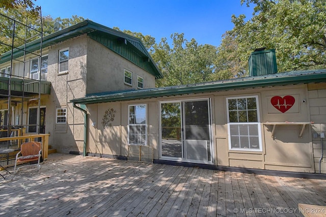 rear view of house featuring a wooden deck