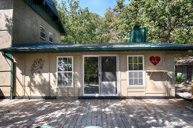 rear view of property with a wooden deck