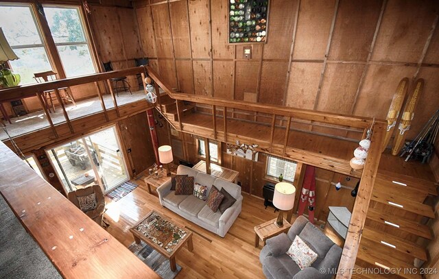 living room with wood walls and hardwood / wood-style floors