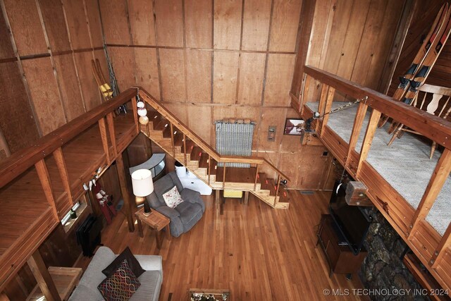 unfurnished living room with wood walls and hardwood / wood-style floors