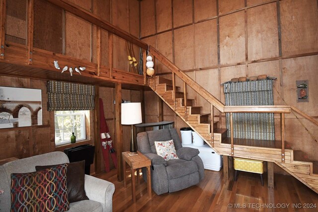 living room with wood walls and hardwood / wood-style flooring