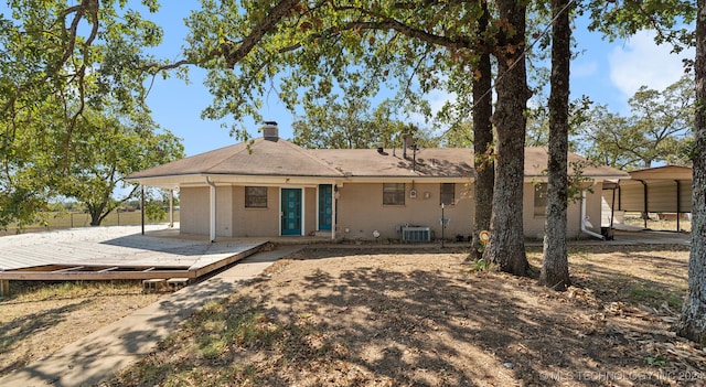 back of house with central AC, a carport, a patio, and a wooden deck