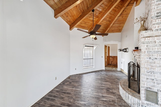 unfurnished living room with a brick fireplace, ceiling fan, wood ceiling, dark hardwood / wood-style flooring, and beam ceiling