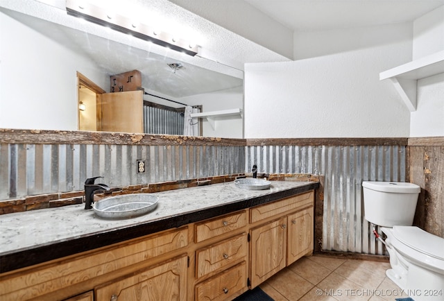 bathroom with vanity, tile patterned flooring, and toilet