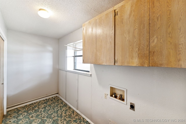 laundry area with a textured ceiling, washer hookup, hookup for an electric dryer, and cabinets