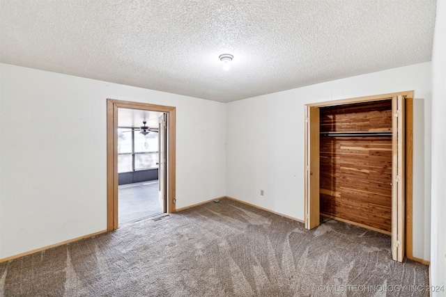 unfurnished bedroom featuring carpet floors, a closet, and a textured ceiling