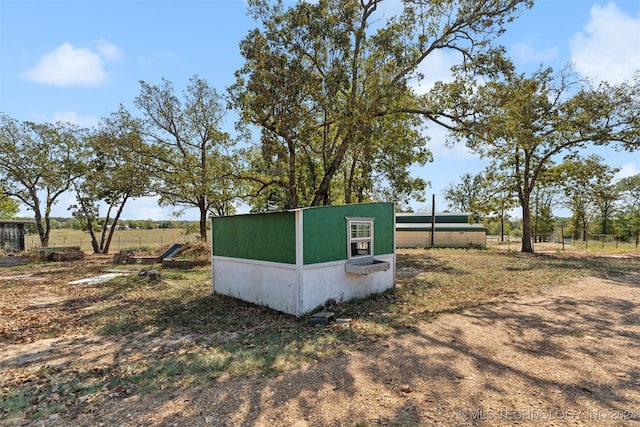 view of outbuilding featuring a rural view