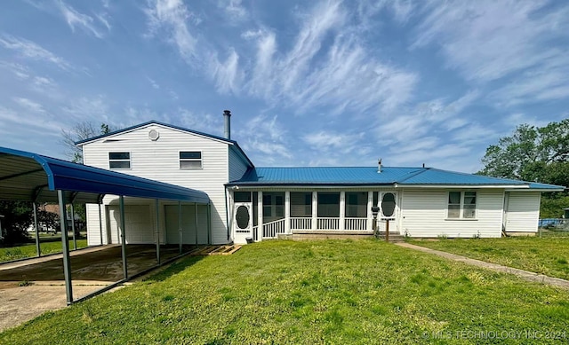 back of property with a yard, a carport, and covered porch