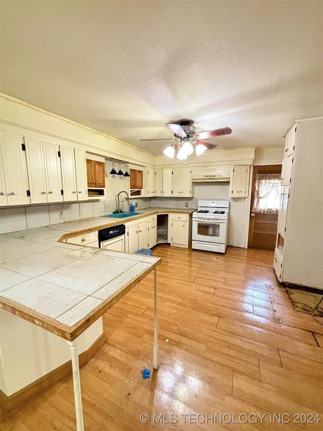 kitchen featuring ceiling fan, white appliances, light hardwood / wood-style flooring, tile countertops, and range hood