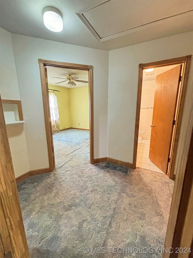 empty room featuring ceiling fan and carpet flooring