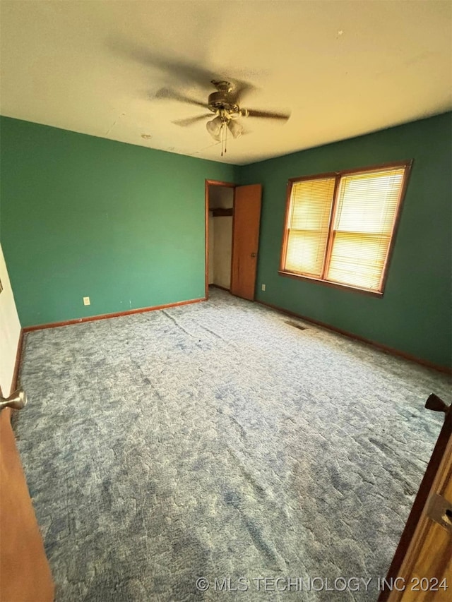 unfurnished bedroom featuring ceiling fan and carpet flooring