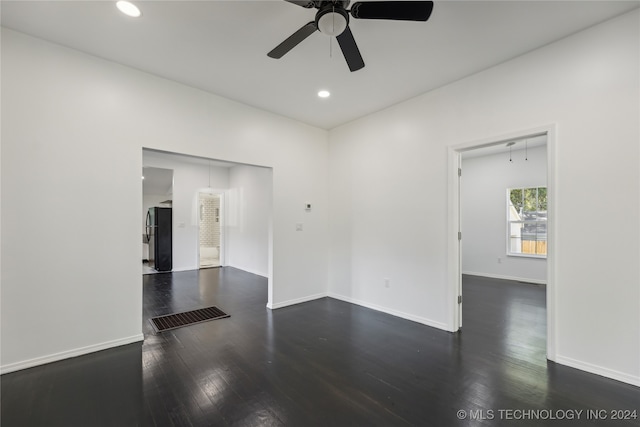 spare room with ceiling fan and dark hardwood / wood-style flooring