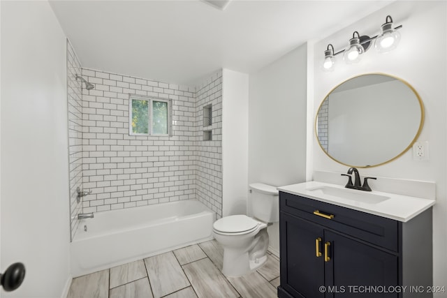 full bathroom with vanity, tiled shower / bath combo, and toilet