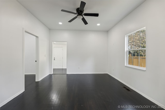 unfurnished room featuring ceiling fan and dark hardwood / wood-style floors