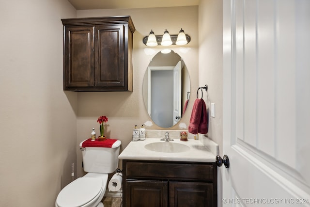 bathroom featuring toilet and vanity