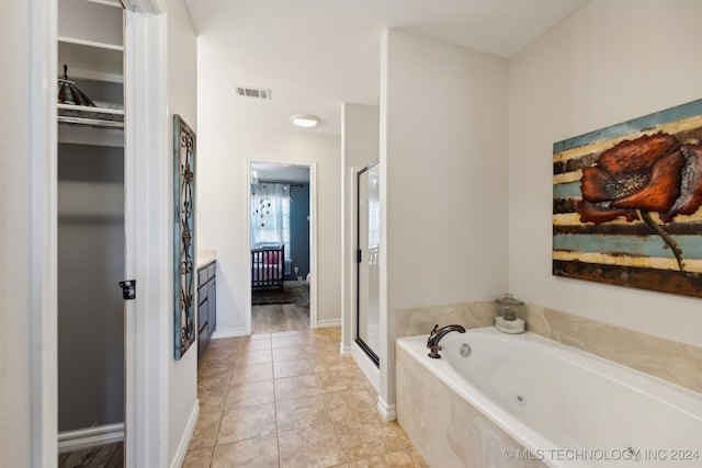 bathroom with vanity, independent shower and bath, and tile patterned flooring