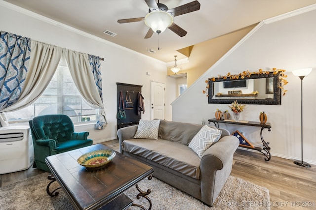 living room featuring ceiling fan, wood-type flooring, and ornamental molding